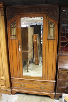 Lot 1328 - Edwardian Art Nouveau walnut wardrobe with glazed panels and 
carved floral scrollwork.