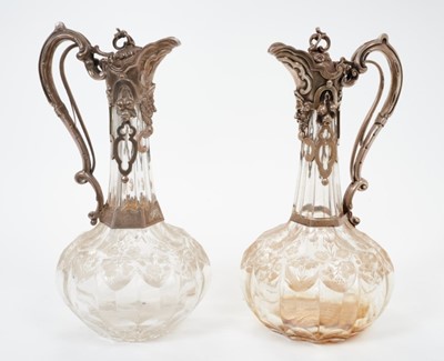 Lot 213 - Near pair Victorian  Cut glass claret jugs of onion form, with silver mounts.