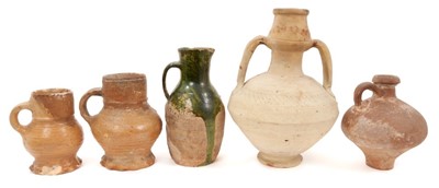 Lot 11 - Two 15th/16th century German salt-glazed stoneware mugs with thumbed footrims, together with a stoneware jug and flask probably of similar age, the largest measuring 26cm high (4)