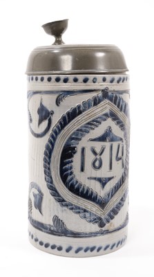 Lot 12 - A German Westerwald stoneware tankard, dated 1814, decorated with incised foliate patterns, pewter lid, total height 25.5cm