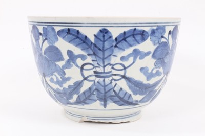 Lot 18 - A Japanese blue and white porcelain bowl, Edo period, painted with a foliate pattern, 16cm high