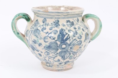 Lot 27 - An unusual Italian maiolica twin-handled pot, with blank scrollwork cartouche, probably an apothecary jar, 11cm high