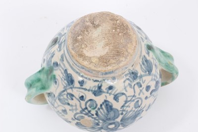 Lot 27 - An unusual Italian maiolica twin-handled pot, with blank scrollwork cartouche, probably an apothecary jar, 11cm high