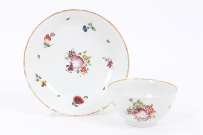 Lot 72 - A Bristol tea bowl and saucer, painted with flowers and fruits, circa 1775