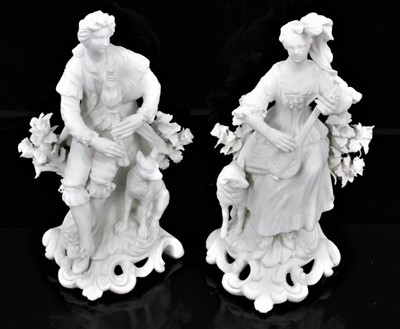 Lot 53 - A pair of Derby bisque figures of a shepherd and shepherdess, shown seated on scrolled rococo bases, the shepherd playing bagpipes and with a hound by his side, the shepherdess playing the lute wit...