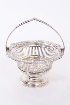 Lot 265 - Edwardian silver swing handled dish of small proportions, with pierced decoration and stylised shell/feather borders