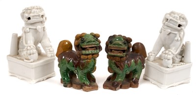 Lot 119 - A pair of Chinese blanc de chine foo dog incense burners