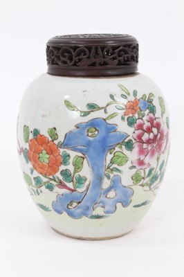 Lot 128 - A Chinese famille rose ginger jar and carved wooden cover, 18th/19th century, painted with peonies and other flowers, 13.5cm high including cover