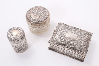 Lot 319 - Victorian silver dressing table box with repoussé floral scroll decoration (London 1884) 11.5 x 8.5 x 4 cm , Victorian silver smelling salts bottle and silver topped cut glass toilet jar (3)