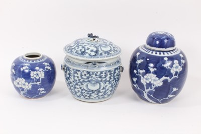 Lot 132 - A 19th century Chinese blue and white bowl and cover, together with two prunus jars, circa 1900 (one with cover)
