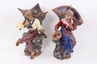 Lot 134 - A large pair of 19th century continental majolica wall pockets, in the form of a fisherman and his wife, impressed 'BU' mark to backs, 46cm high