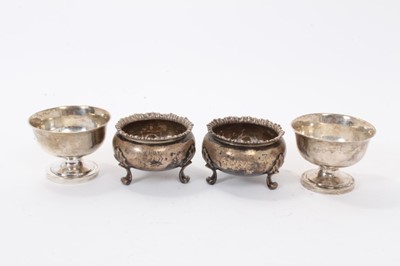 Lot 312 - Pair of Victorian silver salt cellars of cauldron form with gadrooned borders, raised on three scroll feet (London 1845 / 1848), maker George Ivory, together with a pair of 18th century white metal...