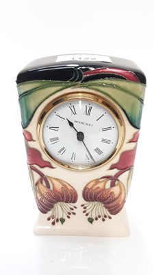 Lot 1122 - Moorcroft pottery mantel clock decorated in the Anna Lily pattern, dated 98, 16cm high, boxed