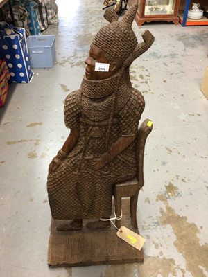 Lot 2592 - Large African carved wooden sculpture of a tribal chief, 98cm, African carved chair, similar panels and carvings.