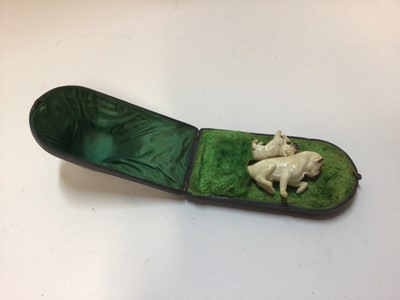 Lot 2402 - Unusual Meerschaum cheroot holders in the form of pug dogs, one with amber stem, in original case, the larger measuring 9.5cm long