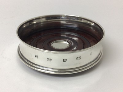 Lot 165 - Contemporary silver wine coaster with turned wooden base