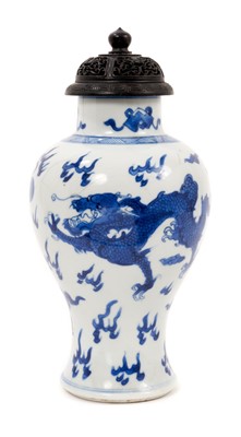 Lot 202 - 19th century Chinese porcelain blue and white baluster shape vase with a carved wooden cover