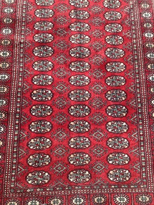 Lot 1300 - Eastern rug with geometric decoration on red ground, 185cm x 119cm