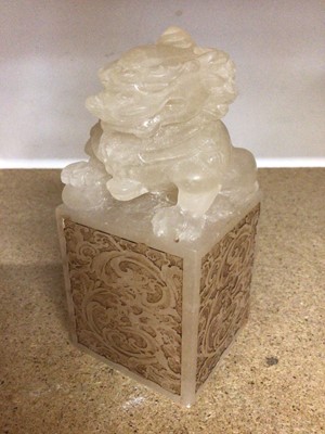Lot 403 - Chinese carved hard stone Foo dog on square base with engraved scroll decoration, 15cm high
