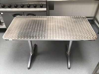 Lot 10 - A brushed stainless steel rectangular top table, with plated column pedestals, 1200 mm x 600 mm