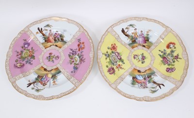 Lot 206 - A large pair of Dresden porcelain dishes, early 20th century, of scalloped form, decorated with figural panels on pink and yellow grounds, 'AR' marks to bases, 36cm diameter