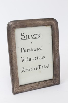 Lot 431 - Edwardian silver photograph frame of vertical rectangular form, with a rounded top and blue velvet easel back (Birmingham 1906) Abraham Meyer Blanckensee. 18cm overall height.