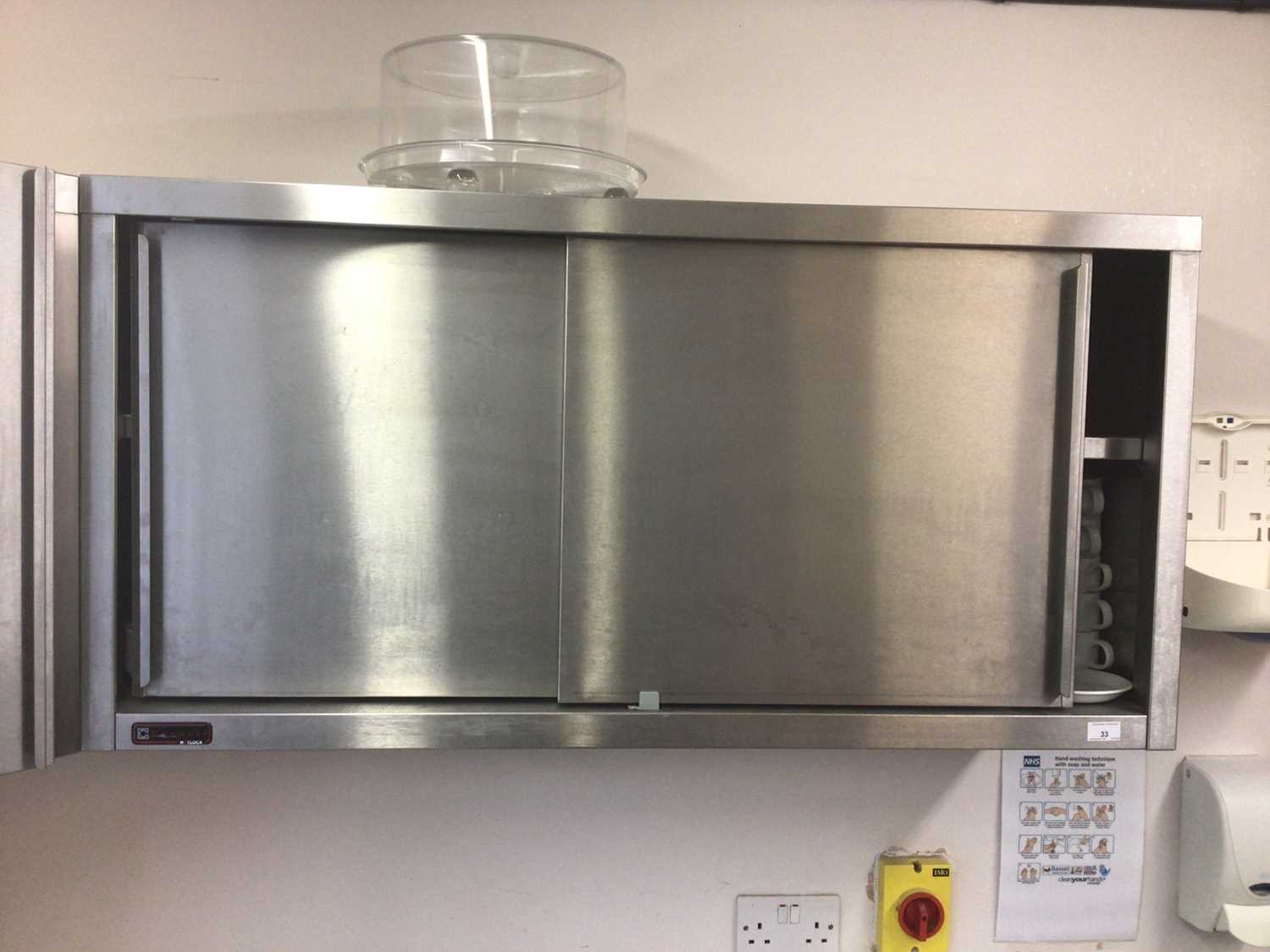 Lot 33 - A stainless steel double sliding door wall cabinet, 1200 mm wide x 340 mm deep