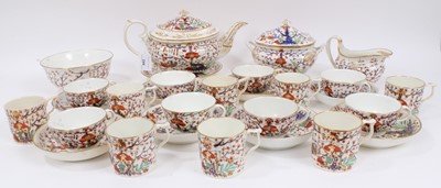 Lot 244 - An early 19th century Crown Derby tea set, decorated in the Imari style, including teapot and stand, sucrier, bowl, seven saucers, eight coffee cans, and eight tea cups