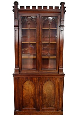 Lot 1424 - 19th century Gothic mahogany two height bookcase, with crenellated cornice and open adjustable shelves flanked by projecting columns, the base with two arched panel doors on plinth base, 110cm wide...
