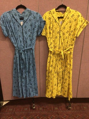 Lot 2097 - Two 1950's classic wrap around day dresses by Swirl Sanforized, fitted bodice and swing skirt in geometic print cotton.