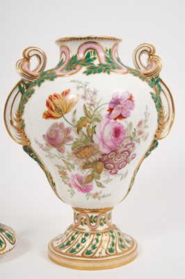 Lot 291 - A Minton Sevres-style vase and cover, circa 1850-70, polychrome decorated with flowers and exotic birds, on a green and pink ground with scrollwork handles, ermine mark to base, 32cm high