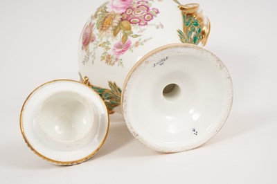 Lot 291 - A Minton Sevres-style vase and cover, circa 1850-70, polychrome decorated with flowers and exotic birds, on a green and pink ground with scrollwork handles, ermine mark to base, 32cm high