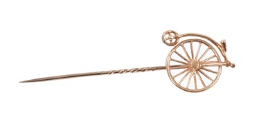 Lot 710 - Antique rose gold stickpin in the form of a Pennyfarthing bicycle with moveable wheel.  Boxed