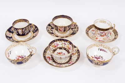Lot 313 - Early 19th century Coalport tea wares, with polychrome floral decoration on gilt patterned grounds, some pieces moulding, including four matching cups and saucers and two further matching cups (10)