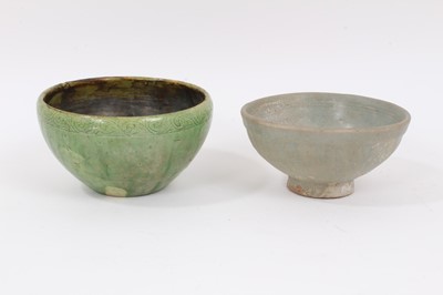 Lot 324 - Two early Chinese green / celadon glazed bowls, one with a ribbed body, the other with incised pattern around the rim, 12cm and 13cm diameter