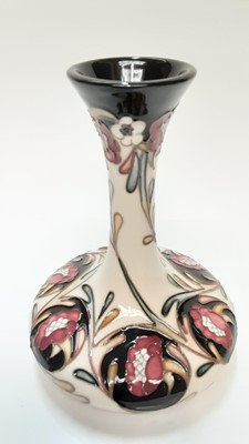Lot 1131 - Moorcroft pottery slender neck vase decorated with flowers on cream and black ground, signed N Slaney, dated 2017, 16cm high