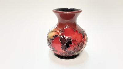 Lot 1134 - Moorcroft pottery vase decorated with red flowers and green leaves on red and blue ground, dated 2013, 9.5cm high