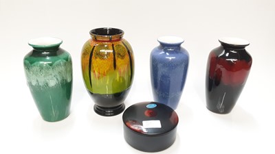 Lot 1164 - Four various Poole vases, together with a circular lidded box containing four coasters