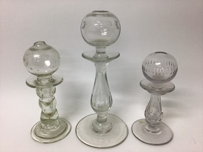 Lot 373 - Three 18th/19th century glass lacemaker's lamps, two with cut decoration