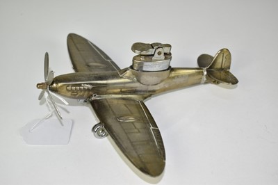 Lot 822 - Diecast table lighter in the form of a Spitfire, marked under wing, 'Spitfire MK9', 21cm in length.