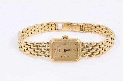 Lot 573 - Ladies Longines 18ct gold wristwatch with rectangular tank shape case with gold dial and applied gold Roman numerals and dot hour markers,  quartz movement in gold case on 18ct gold bracelet, in bo...