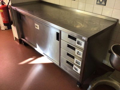 Lot 66 - A Moffat stainless steel wall standing kitchen base unit, with twin sliding door cupboard and four drawers, on castors, 1800 mm