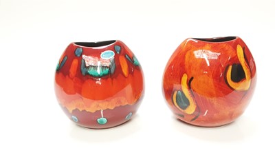 Lot 1213 - Two Poole Purse vases, 19.5cm high