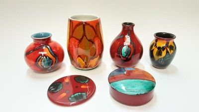 Lot 1221 - Poole Dephis vase with abstract decoration on orange, yellow and green ground, 15cm high, together with five other pieces of Poole pottery including vases (6)