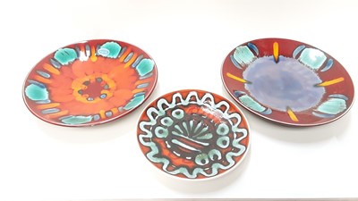 Lot 1287 - Two Poole Volcano dishes, 26cm diameter, together with another Poole plate, 20cm diameter