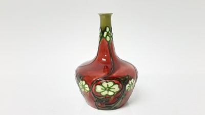 Lot 1343 - A Minton Secessionist style vase, decorated with a foliate pattern on a red ground