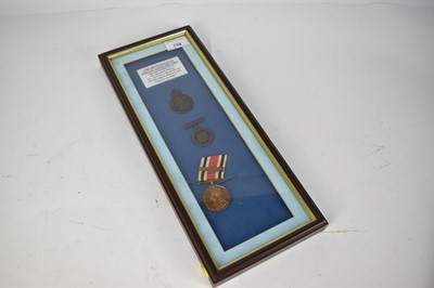 Lot 710 - George V Special Constabulary Long Service medal named to Rev. Harold P. Browne, mounted in a glazed frame with associated badges.