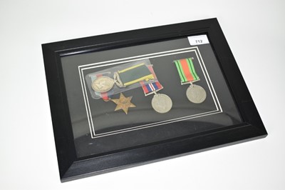 Lot 712 - Second World War trio comprising 1939 - 1945 Star, War medal with M.I.D. Oak leaf and Defence medal (mounted in frame), together with a George VI Territorial Efficiency medal named to T.79321 CPL....