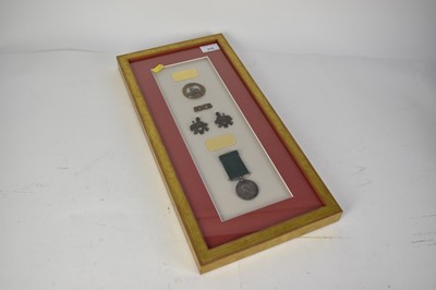 Lot 713 - Victorian Volunteer Long Service and Good Conduct medal named to PT E. Browne. 4. V. S.W.B., mounted in glazed framewith associated badges.  
N.B. naming on medal possibly unofficially done.