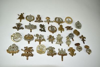 Lot 723 - Collection of thirty military cap badges to include Carnarvonshire Volunteer Regiment, The Buffs and Royal Welch Fusiliers (30 badges)